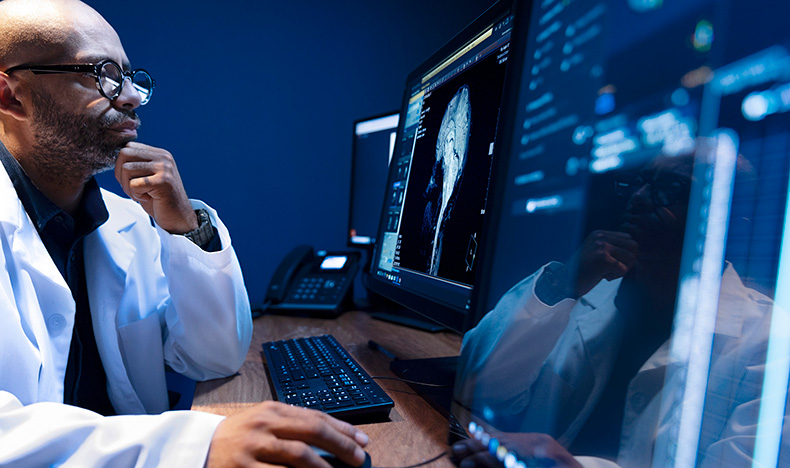 A radiologist examining a patient case on a screen